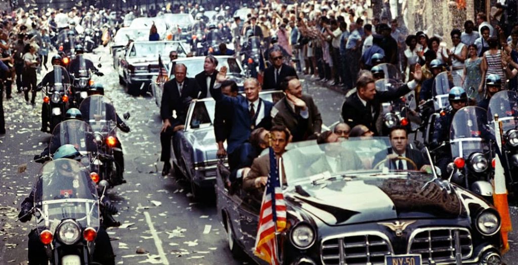 Ticker-tape parade for the Apollo 11 astronauts in Manhattan, New York City. Pictured in the lead car, from the left to right, are astronauts Edwin E. 'Buzz' Aldrin Jr., Michael Collins and Neil A. Armstrong (1969)
