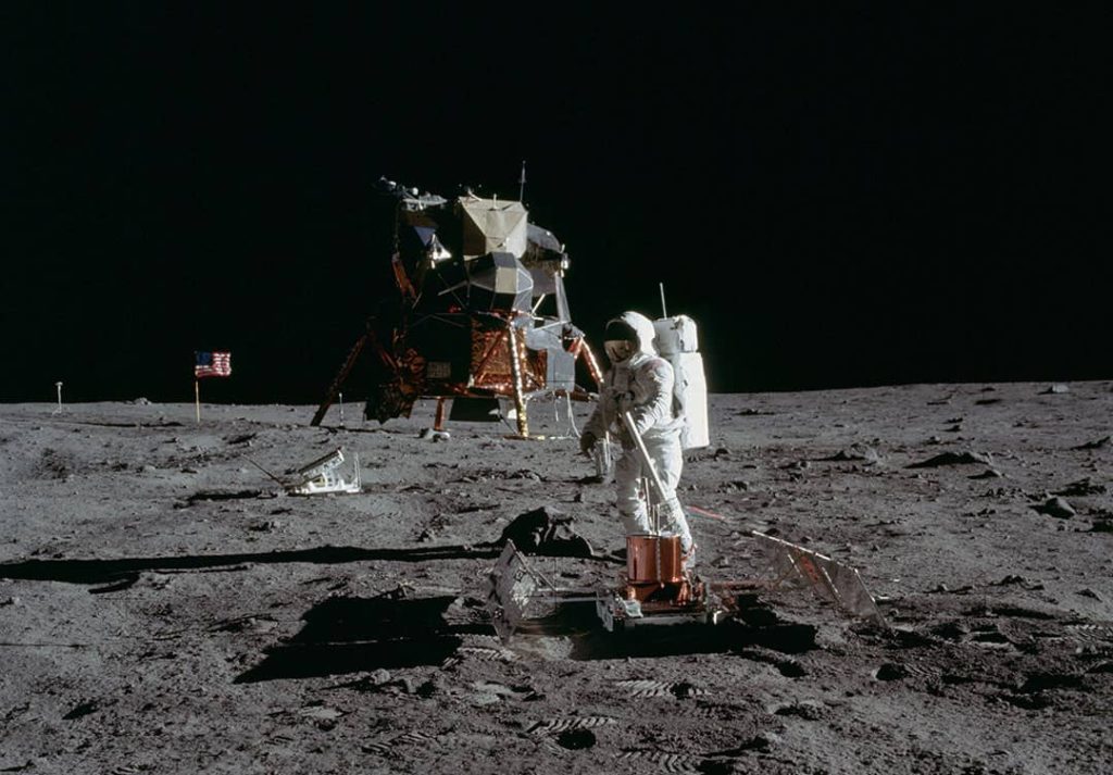 Astronaut Edwin E. 'Buzz' Aldrin Jr. leveling the 'Passive Seismic Experiments Package' whilst standing on the surface of the Moon (1969)
