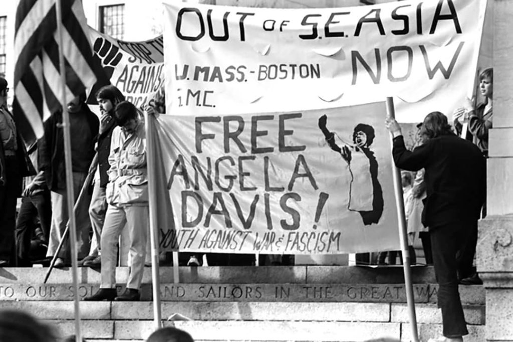 Vietnam anti-war protest with banners sayin 'Out of S.E. Asia Now' and 'Free Angela Davis. Youth against war and fascism', Boston, Massachusetts, USA (1970)