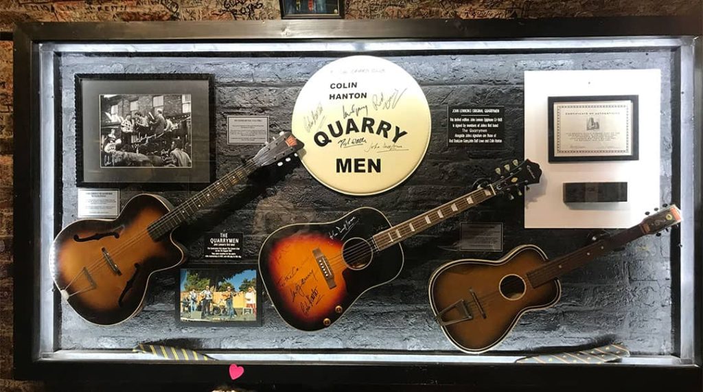 Photograph of the framed acoustic guitars and other memorabilia from 'The Quarrymen' displayed in the Cavern Club (2019)