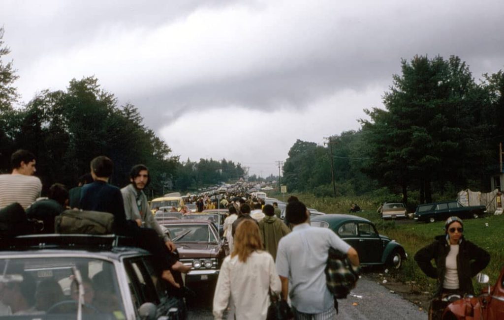 Hundreds of people and cars on the Route 17B heading to the 'Woodstock Music and Art Fair' (1969)