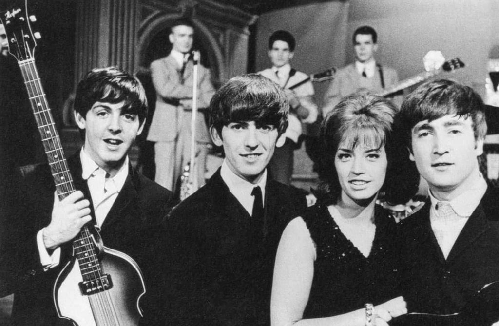 From left to right: Beatles' members Paul McCartney and George Harrison, followed by Lill-Babs and John Lennon with The Telstars performing in the background (1963)