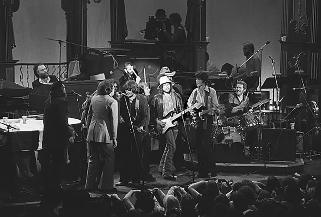 Photograph of 'The Last Waltz', The Band with Bob Dylan and other renowned guests such as Ringo Starr, Dr. John, Neil Diamond, Joni Mitchell, Neil Young, Van Morrison, Ronnie Hawkins, Eric Clapton, and Ron Wood performing 'I Shall Be Released' (1976)