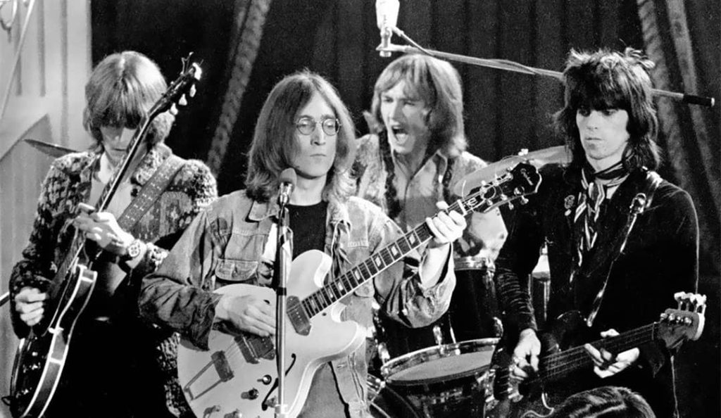 Eric Clapton, John Lennon, Mitch Mitchell, and Keith Richards performing as the 'Dirty Mac' in the 'Rolling Stones Rock and Roll Circus' (1968)