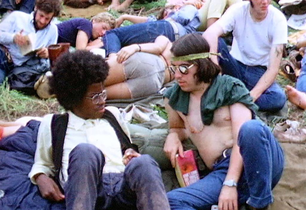 Two concert attendees laying down at the Woodstock Festival (1969)