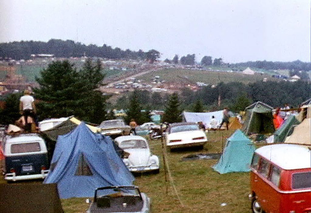 Tents at the Woodstock Festival camping site along with some classic cars such as the Volkswagens Beetle (1969)
